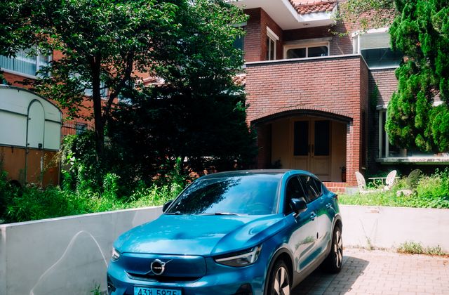 Voiture électrique devant une maison, recharge bidirectionnelle V2G